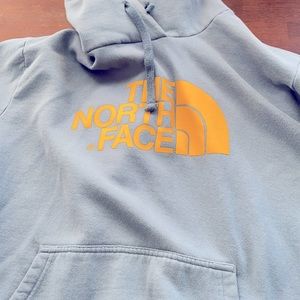 The North Face Hoodie. Excellent shape. Light blue and yellow logo.